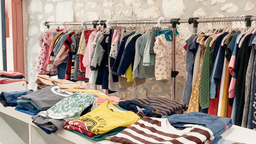 Vêtements enfants d'occasion suspendus et pliés en boutique ColChic Bourges